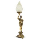 Ornate brass table lamp with frosted flame glass shade in the form of a soldier wearing 17th century