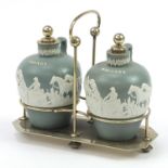 19th century brandy and whiskey salt glazed flagons housed in a silver plated tantalus, the