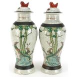 Pair of Chinese crackle glaze baluster vases and covers hand painted in the famille verte palette