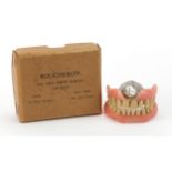 Pair of dentures with gold fillings and white metal plate housed in a Boucheron 180 New Bond