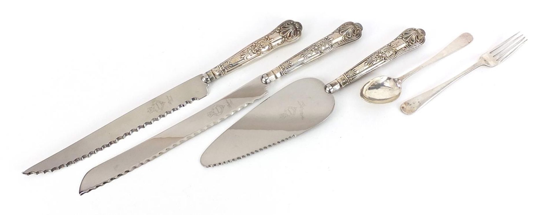 Silver items comprising teaspoon, fork, two silver handled bread knives and a silver handled cake