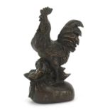 Japanese patinated bronze rooster standing on a sack, impressed marks to the base, 9.5cm high