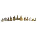Twelve brass and white metal Crinoline Lady table bells, the largest 10.2cm high