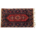 Rectangular Turkish red and blue ground rug having an all over abstract design, 185cm x 118cm
