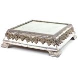 Square silver plated mirrored cake stand relief decorated with grapes on a vine, housed in a painted