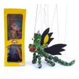 Two vintage Pelham puppets comprising boy with box and a dragon, the largest 50cm in length