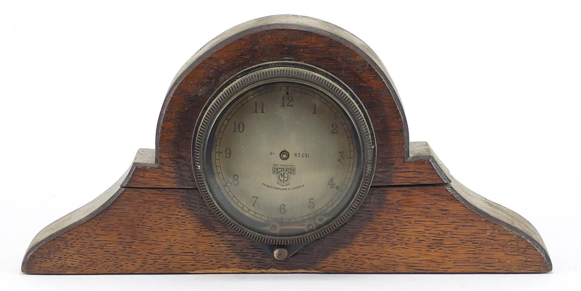 Vintage Smiths car clock housed in an oak frame, the clock numbered 63.051, 26.5cm wide