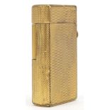 Dunhill gold plated pocket lighted with engine turned decoration, 6cm high