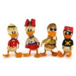 Four vintage Disney style duck toys, the largest 16cm high