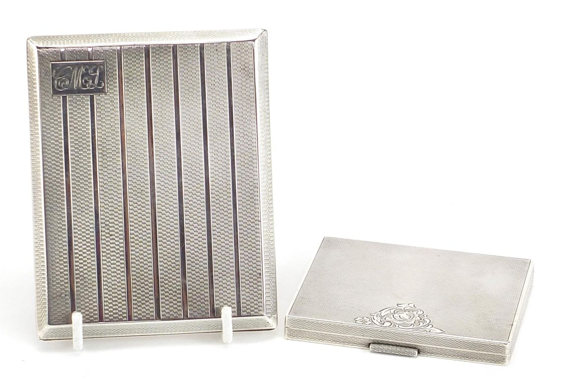 Two rectangular silver cigarette cases with engine turned decoration, the largest by Deakin &