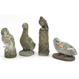 Four garden stoneware birds including woodpecker and owl, the largest 47cm high