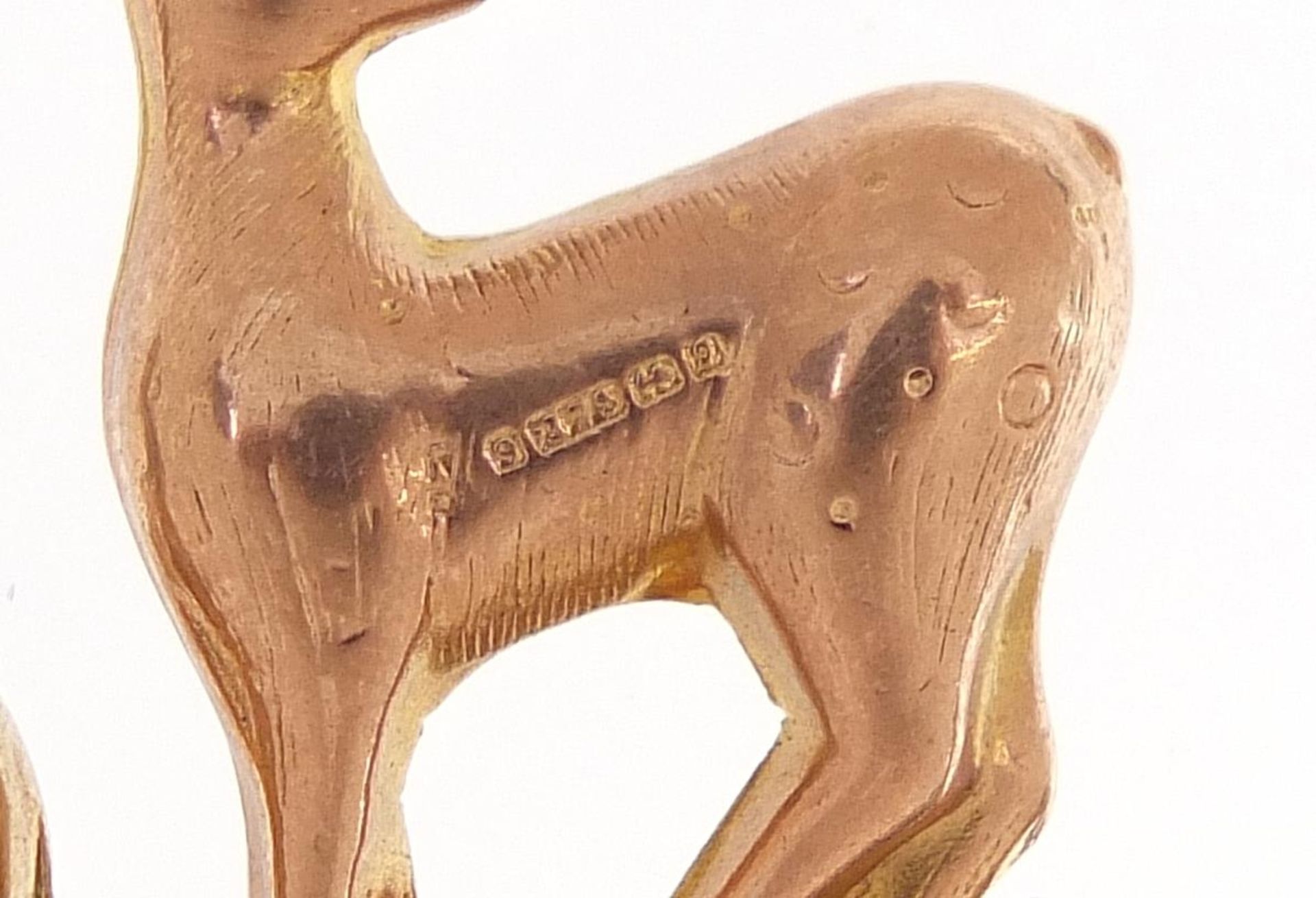 Three 9ct gold charms comprising Dachshund, deer and fish, the largest 2.5cm in length, total 3.8g - Image 3 of 3
