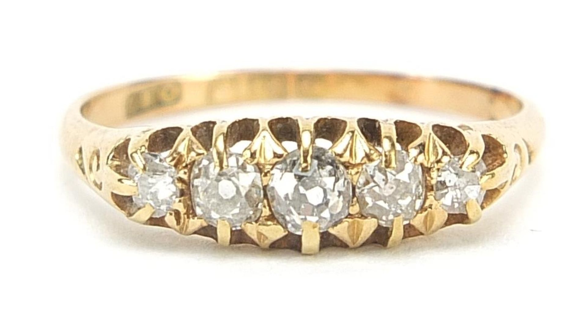 18ct gold diamond five stone ring, the largest diamond approximately 3.5mm in diameter, size R, 3.1g