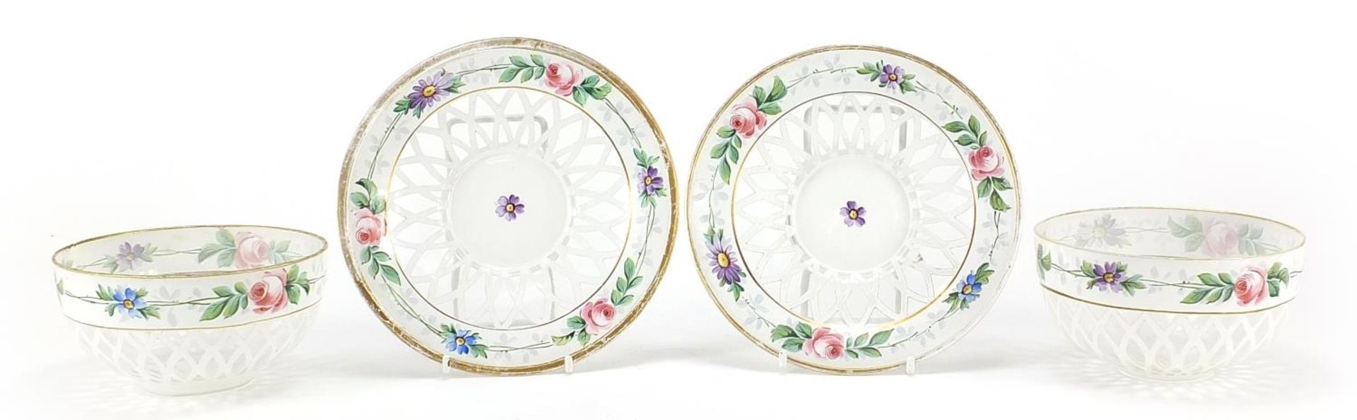 Pair of Bohemian white overlaid glass bowls with saucers, hand painted with flowers, each saucer