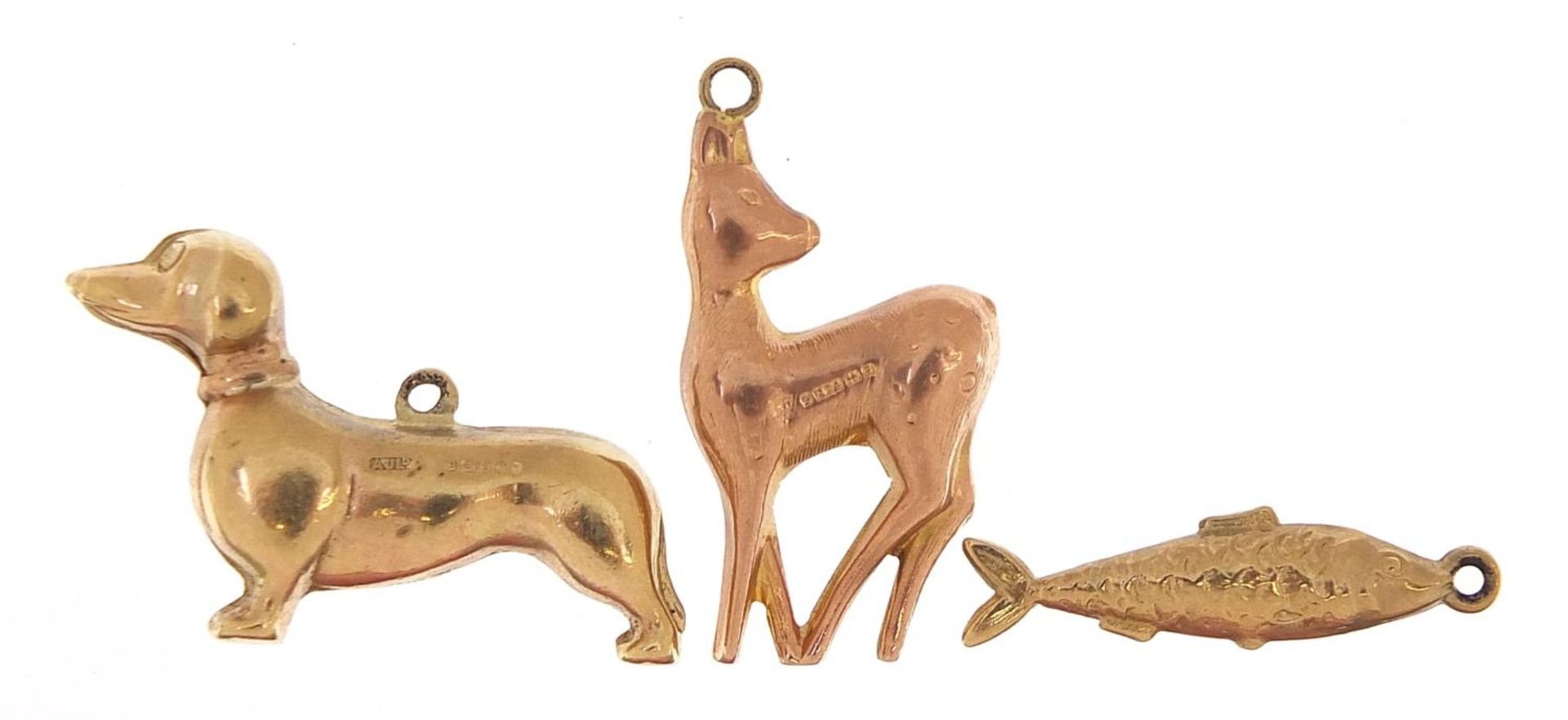 Three 9ct gold charms comprising Dachshund, deer and fish, the largest 2.5cm in length, total 3.8g - Image 2 of 3