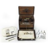 Vintage leather doctor's travelling medical case with various implements, lift up top and fold