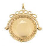 Unmarked gold spinner locket with engraved decoration, (tests as 9ct gold) 3.8cm high, 5.4g