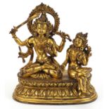 Chino Tibetan gilt bronze figure of two deities sitting on a lotus leaf, 16cm wide