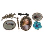 Seven antique and later brooches including an oval portrait brooch hand painted with a female,
