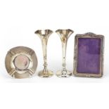 Silver items comprising pair of Mappin & Webb bud vases, easel photo frame and circular ashtray, the