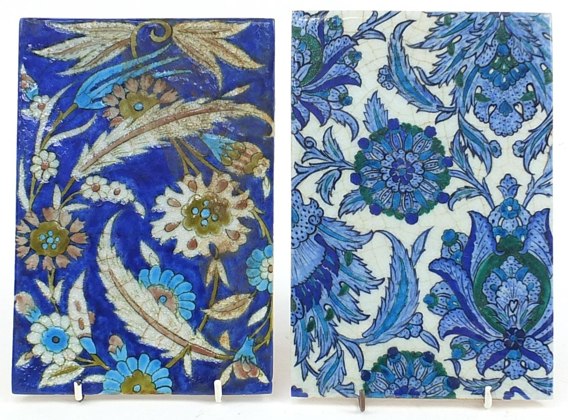 Two Turkish Iznik pottery tiles hand painted with leaves and flowers, each approximately 23.5cm x