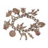 Silver charm bracelet with a selection of mostly silver charms, 61.0g