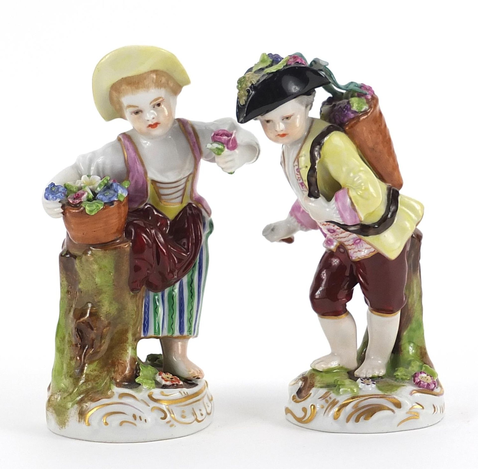 Pair of Chelsea style porcelain figures with flowers, the largest 12.5cm high