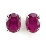 Pair of silver oval ruby stud earrings, 7mm high, 1.2g