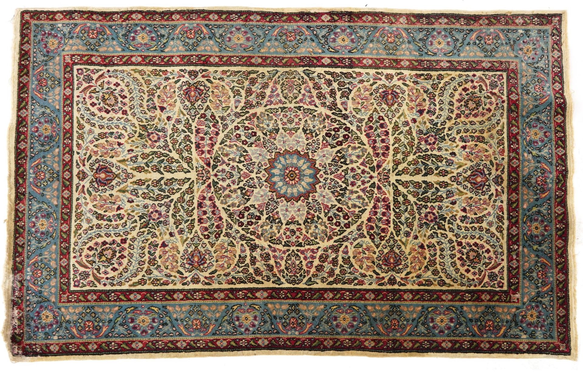 Rectangular Persian cream and blue ground rug having an all over floral design, 182cm x 125cm