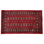 Rectangular Bokhara red ground rug having an all over geometric design, 154cm x 96cm
