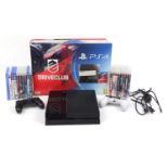 PlayStation 4 games console with a collection of PlayStation 4 and PlayStation 3 games