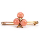 Unmarked gold coral and seed pearl bar brooch, (tests as 9ct gold) 3.8cm wide, 2.4g