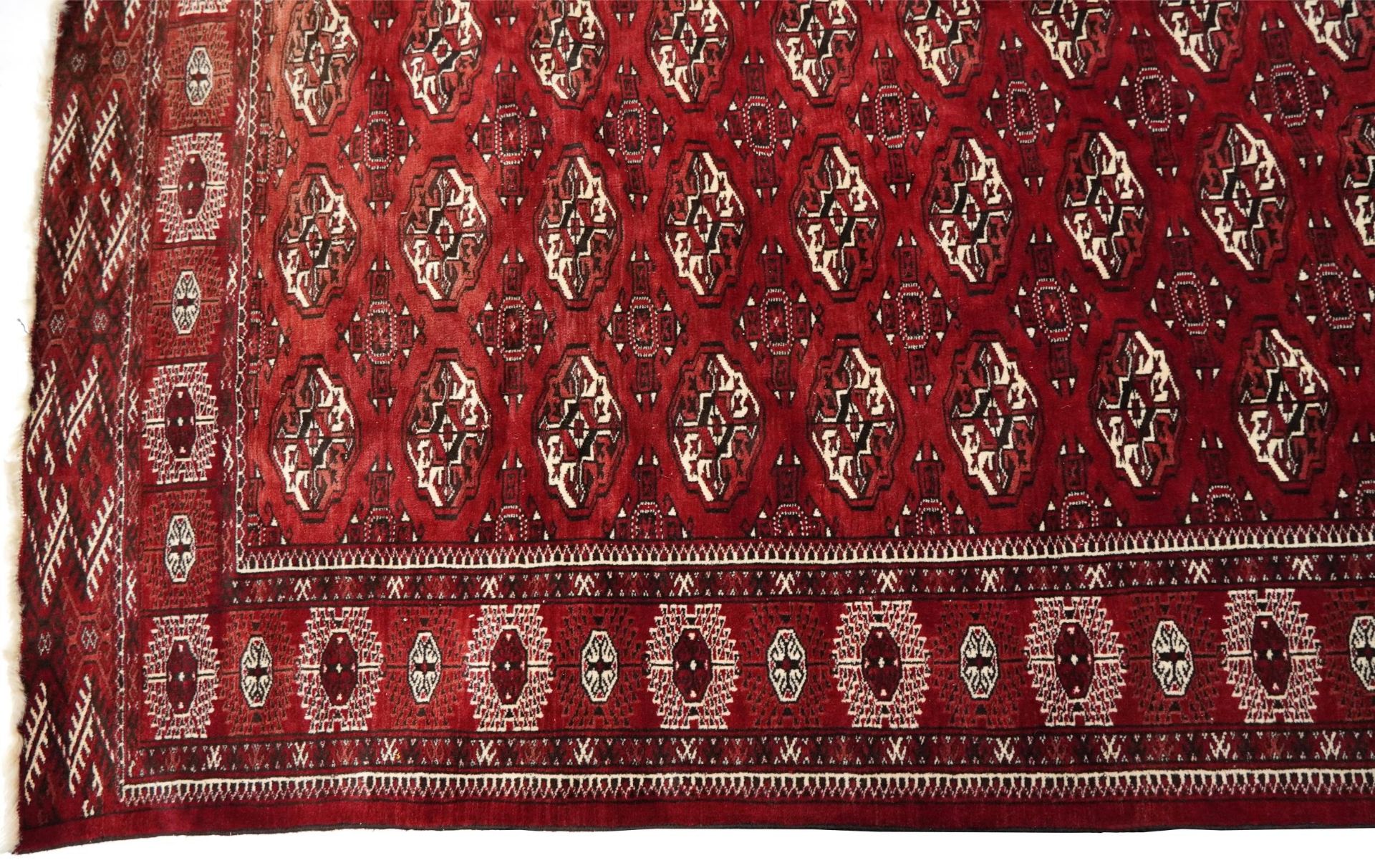 Rectangular Persian Turkmen red ground carpet having an all over geometric design, 345cm x 215cm - Image 5 of 8