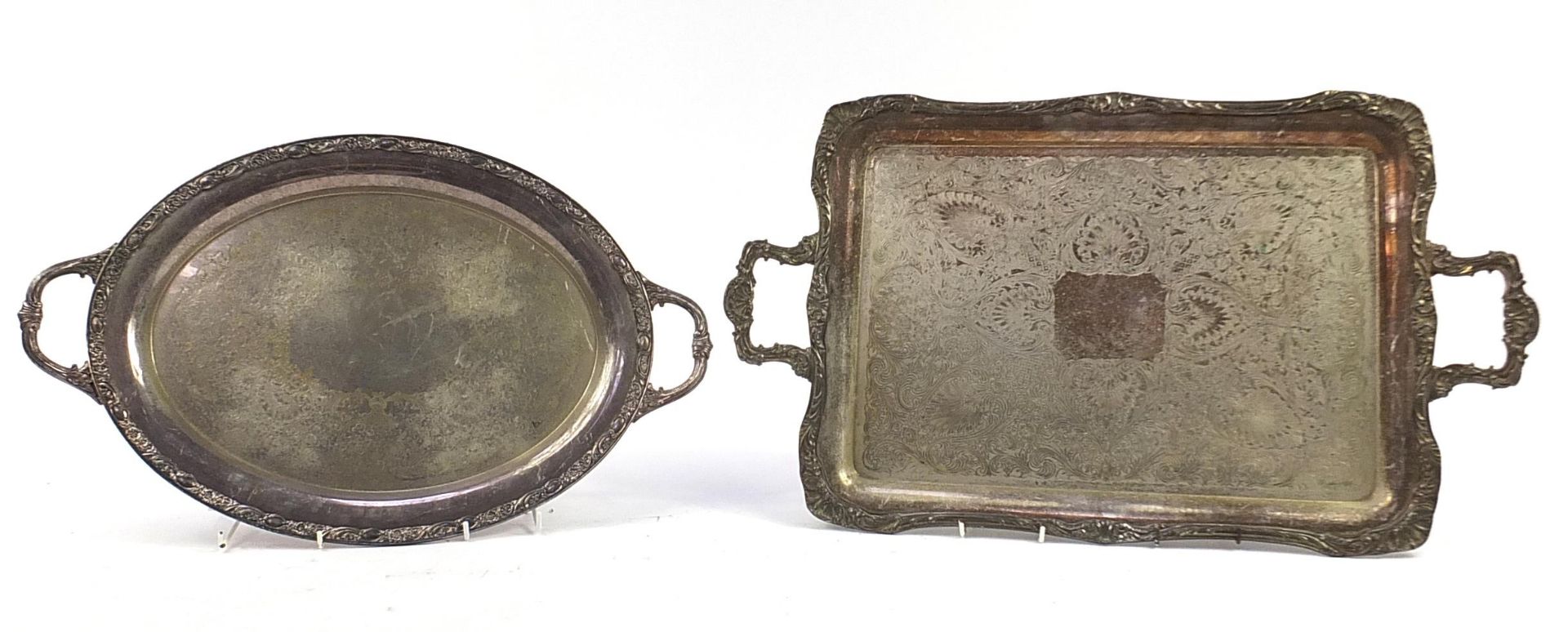 Two heavy silver plated trays with twin handles, the largest 72cm wide