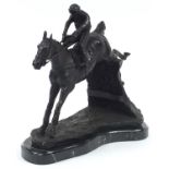 Large patinated bronze jockey on horseback raised on a black marble base, 35cm in length
