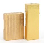 Two gold plated engine turned pocket lighters comprising Dunhill and S J Dupont, the largest 6.5cm