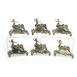 Set of six white metal Putti design menu holders, each 6cm wide