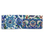 Pair of Turkish Iznik pottery tiles hand painted with flowers, each approximately 24cm x 16.5cm