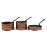 Three antique copper and iron preserve pans including one by Jones Bros of Downing Street, the