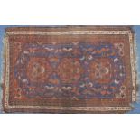 Rectangular red and blue ground rug having an all over geometric design, 165cm x 120cm