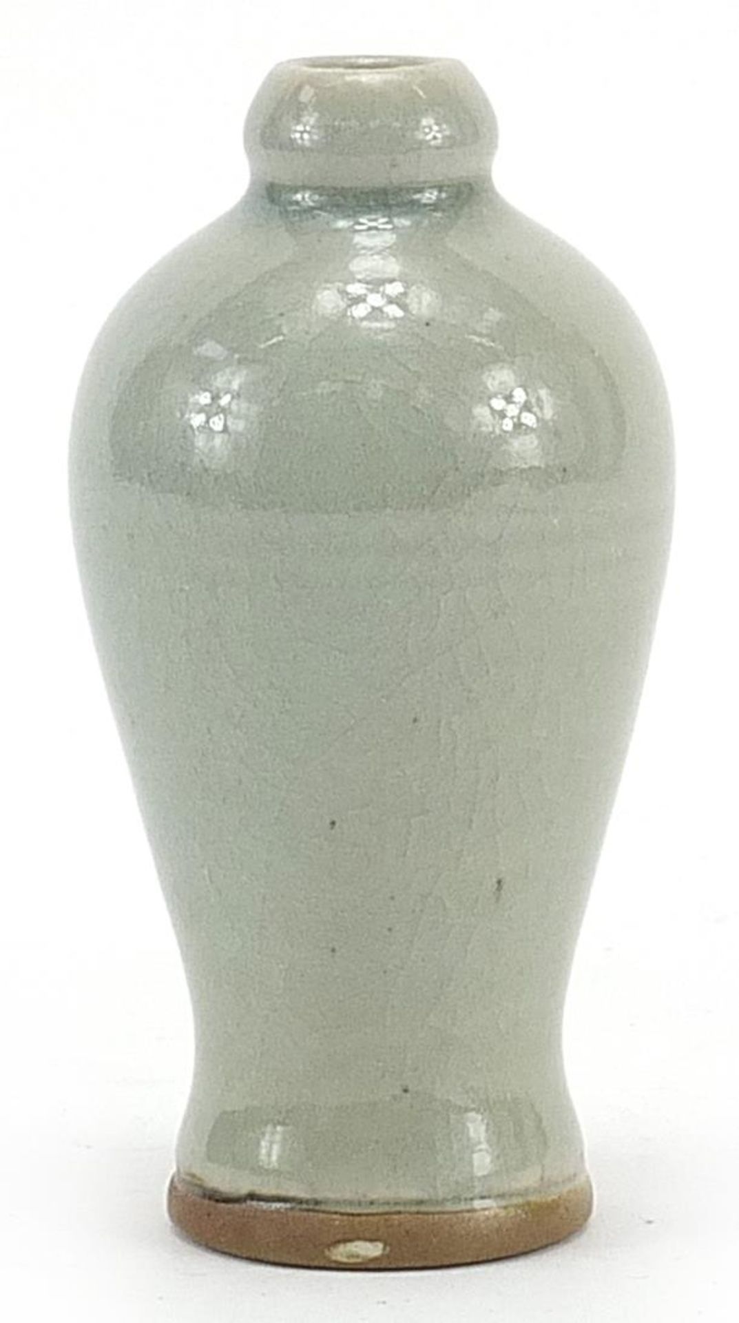 Chinese porcelain baluster shaped vase having a celadon glaze, 13cm high