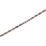 14ct gold oval tanzanite and round brilliant cut diamond bracelet with certificate, approximate