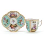 Meissen, German porcelain cup with saucer hand painted with panels of figures and flowers, the