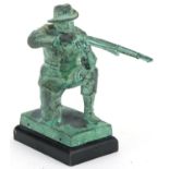 Verdigris patinated metal statue of a hunter holding a shotgun, 15cm high