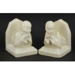 Pair of Art Deco cream glazed bookends in the form of females, 10.5cm high
