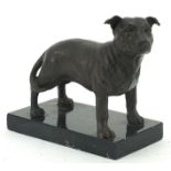 Patinated bronze Staffordshire Bull Terrier raised on a black marble base, 15cm in length
