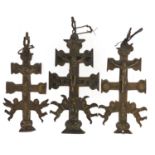 Three Spanish bronzed crucifixes, the largest 13cm high