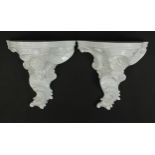 Pair of white glazed porcelain shelf brackets, 29cm high