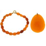 Amber coloured pendant and an amber coloured bead bracelet with 9ct gold clasp, the bracelet 19cm in