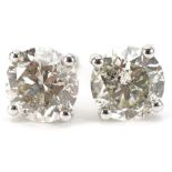 Pair of 18ct white gold round brilliant cut diamond solitaire stud earrings, total diamond weight